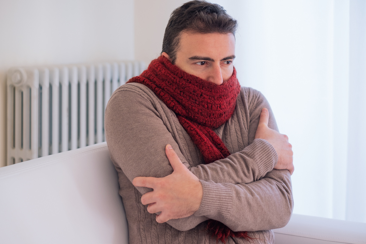 Man freezing and shivering at home because of winter cold